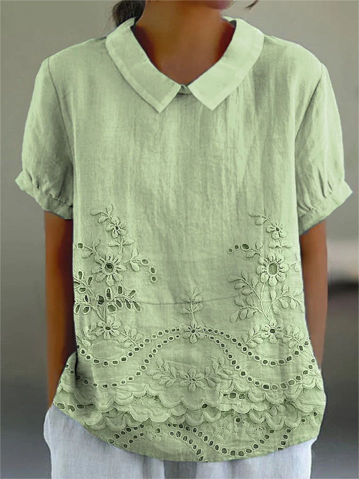 Veda Bremen Lily besticktes Blumenhemd with colorful floral embroidery, long sleeves, and button-up front on white fabric.