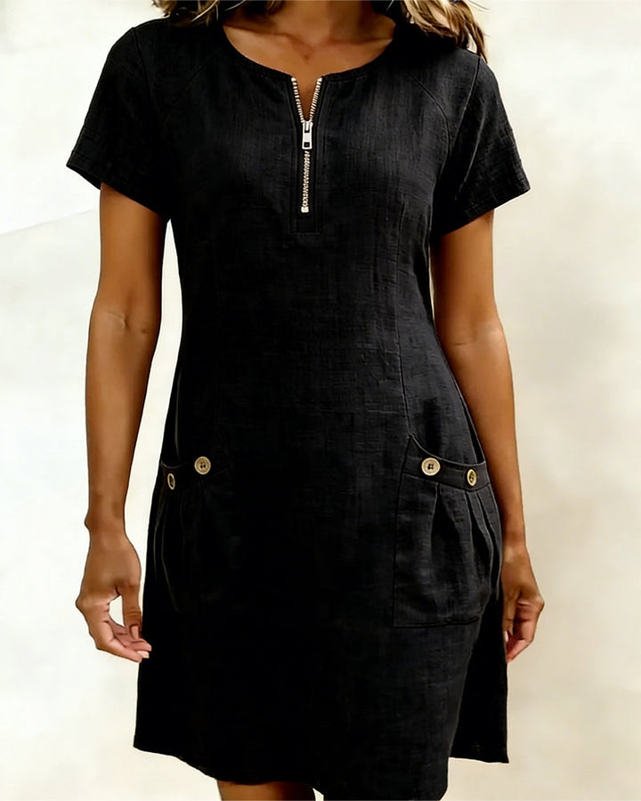 Veda Bremen Dariae linen blend A-line dress displayed on a hanger, showcasing its flowing silhouette and lightweight fabric