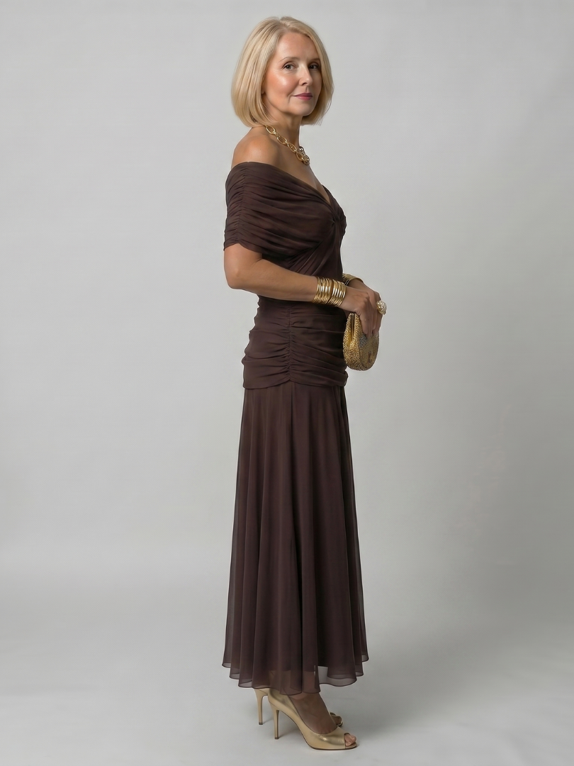 Veda Bremen Calen off-shoulder midi dress with flowing fabric, stylish design, and elegant silhouette on white background.