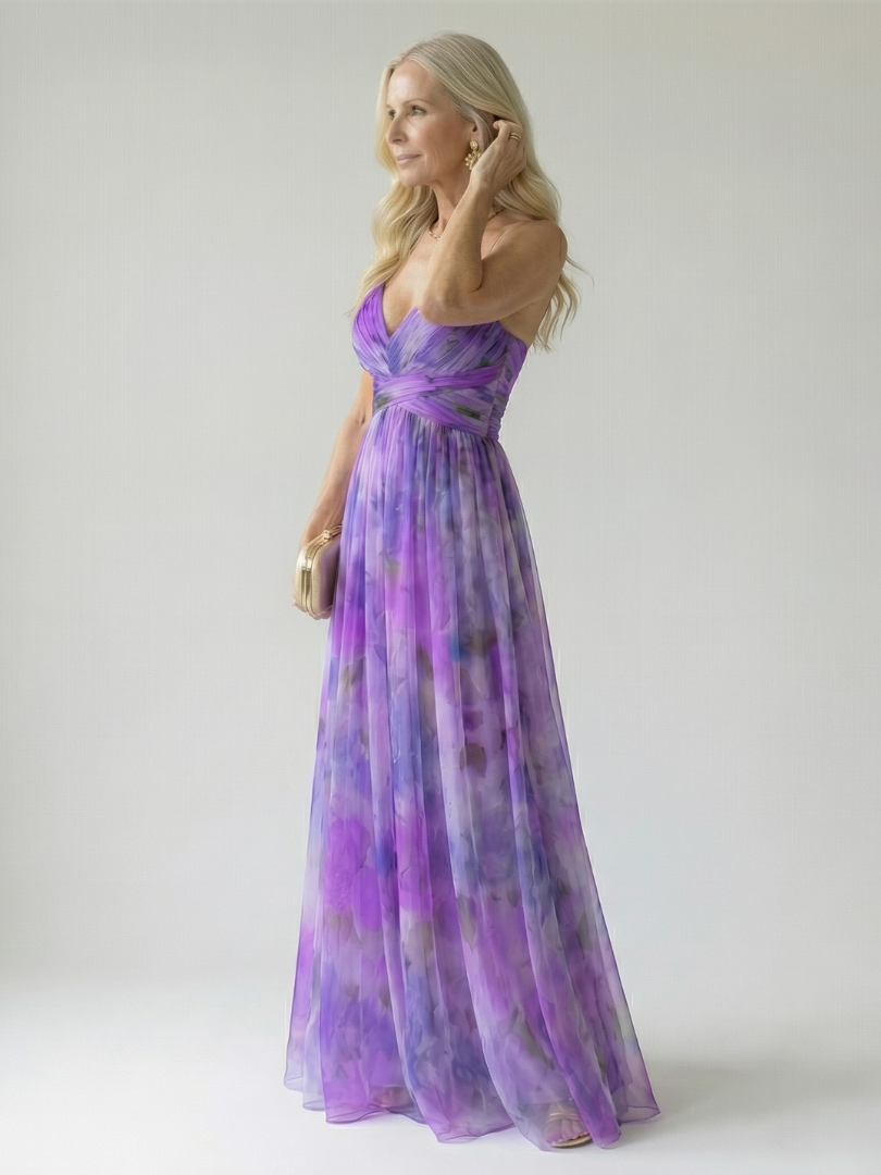 Veda Bremen Isel soft wrap maxi dress in flowing fabric, shown hanging on a hanger against a white background.