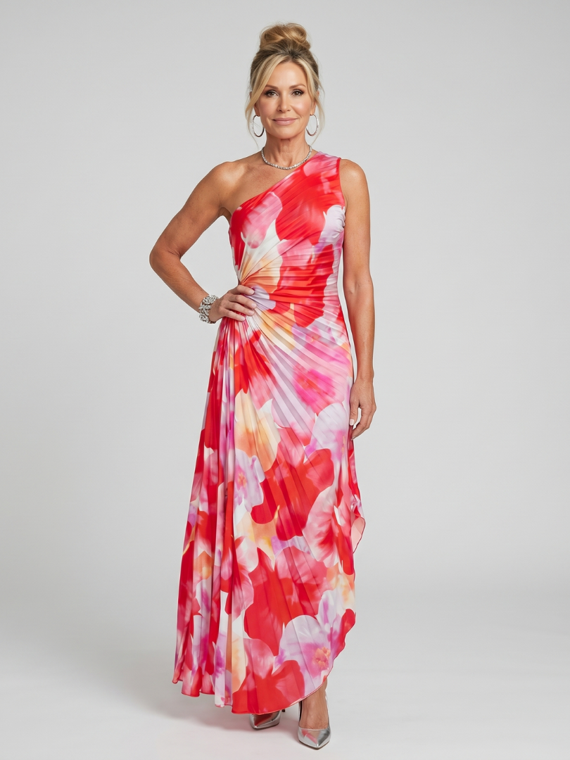 Veda Bremen Taya midi dress with one-shoulder strap and pleated bodice, shown on a hanger with floral background