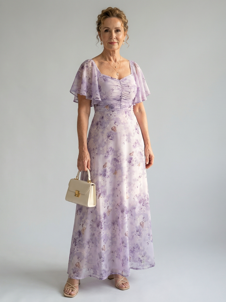 Veda Bremen Vaelis mid-length dress with flutter sleeves, flowing fabric, and a stylish, elegant design.