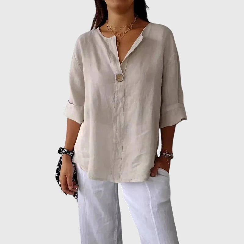 Veda Bremen Valentina blouse in light fabric with long sleeves and a relaxed fit, displayed on a hanger.