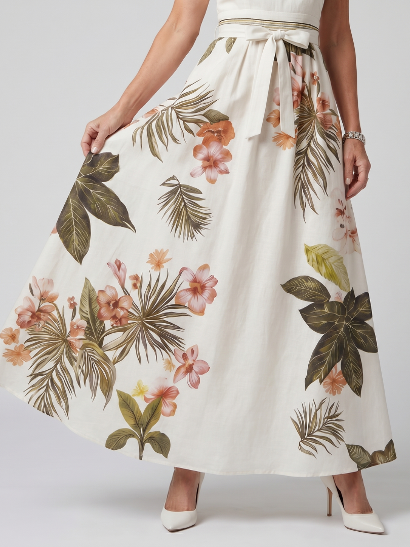 Veda Bremen Meadow maxi dress with neckholder, draped fabric, and botanical accents, shown on a model.