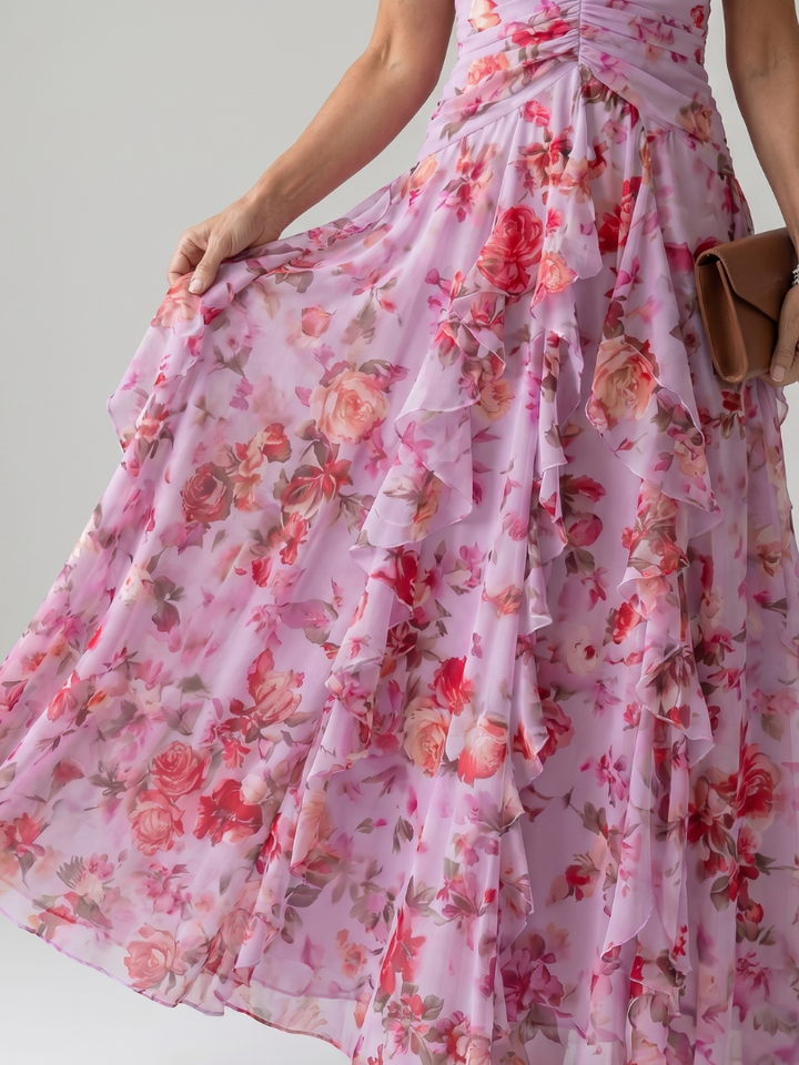 Veda Bremen Nori maxi dress with neckline tie, ruffled top, and floral print, shown on a model.