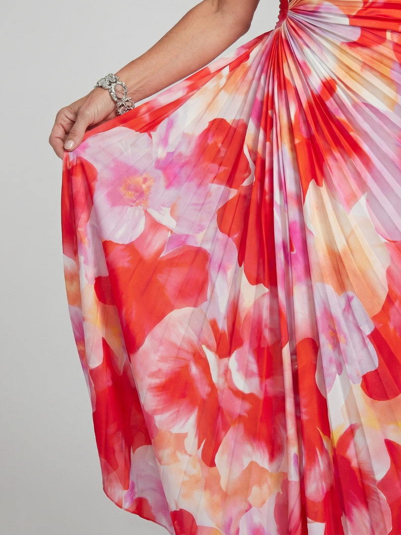 Veda Bremen Taya midi dress with one-shoulder strap and pleated bodice, shown hanging on a clothing rack.