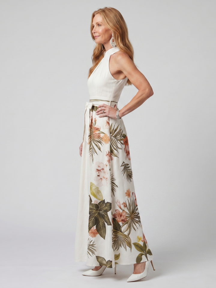 Veda Bremen Meadow maxi dress with neckholder, draping, and botanical accents, shown in a flowing design with floral details.