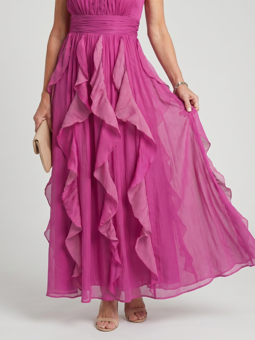 Veda Bremen Orea maxi dress with high neckline, gathered details, and layered ruffle accents, shown on a model.