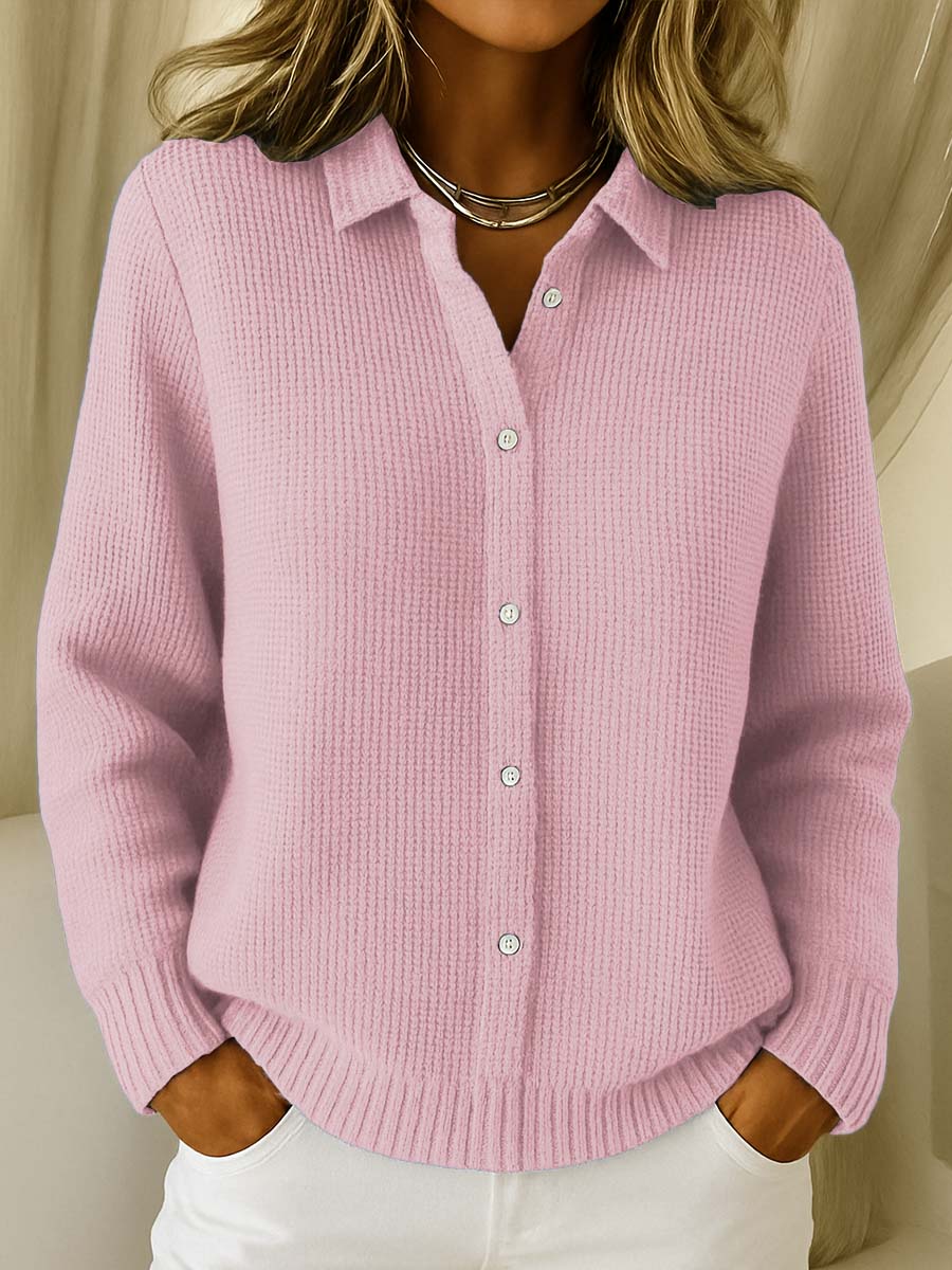 Cream Sally Ava Mae classic knit button cardigan with ribbed cuffs and front buttons, styled on a hanger against a neutral background.