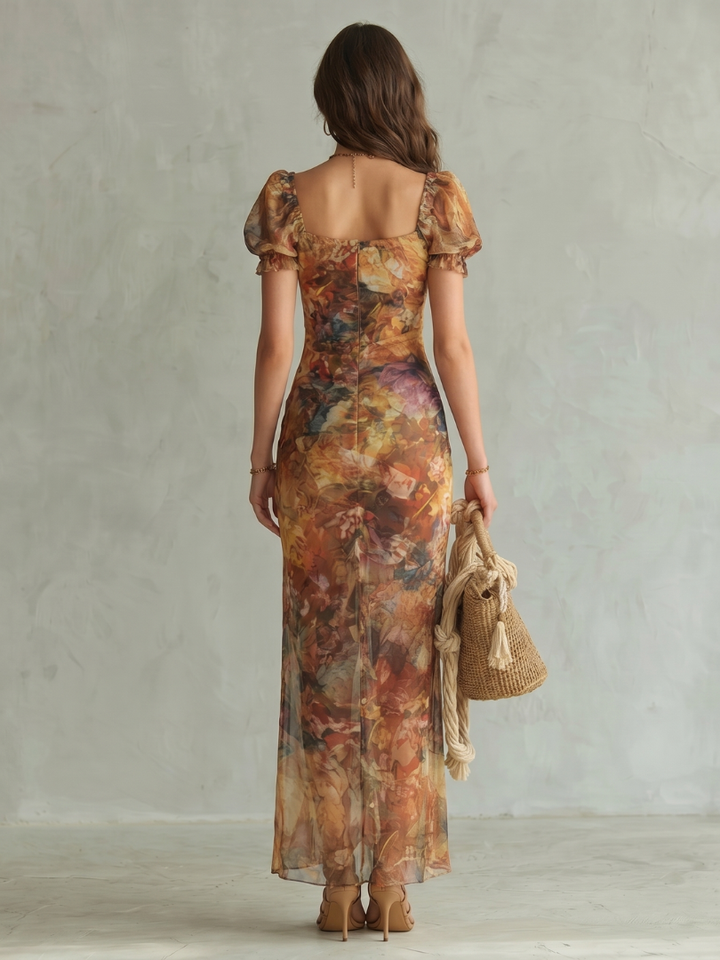 Veda Bremen Ciel mid-length dress with ruffled sleeves, gathered waist, and thigh slit, showcasing stylish and feminine design.