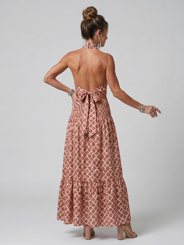 Veda Bremen Amira midikleid with cross-front neckholder, geometric print, and cut-out detail, shown on a model.