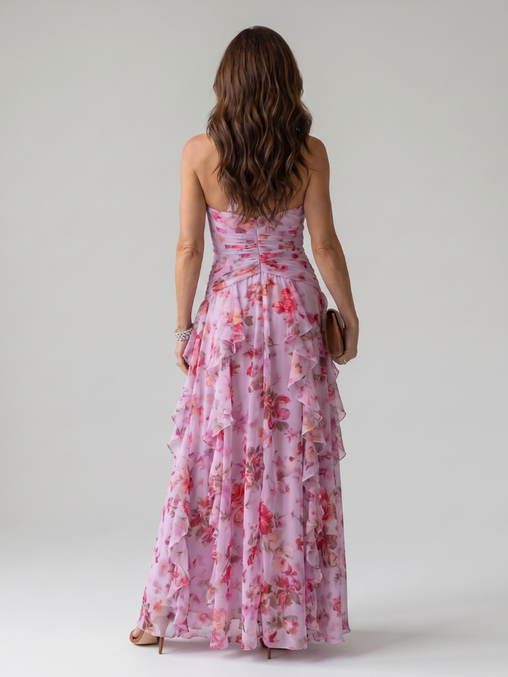 Veda Bremen Nori maxi dress with neckholder, gathered top, and floral print, shown on a hanger against a neutral background.