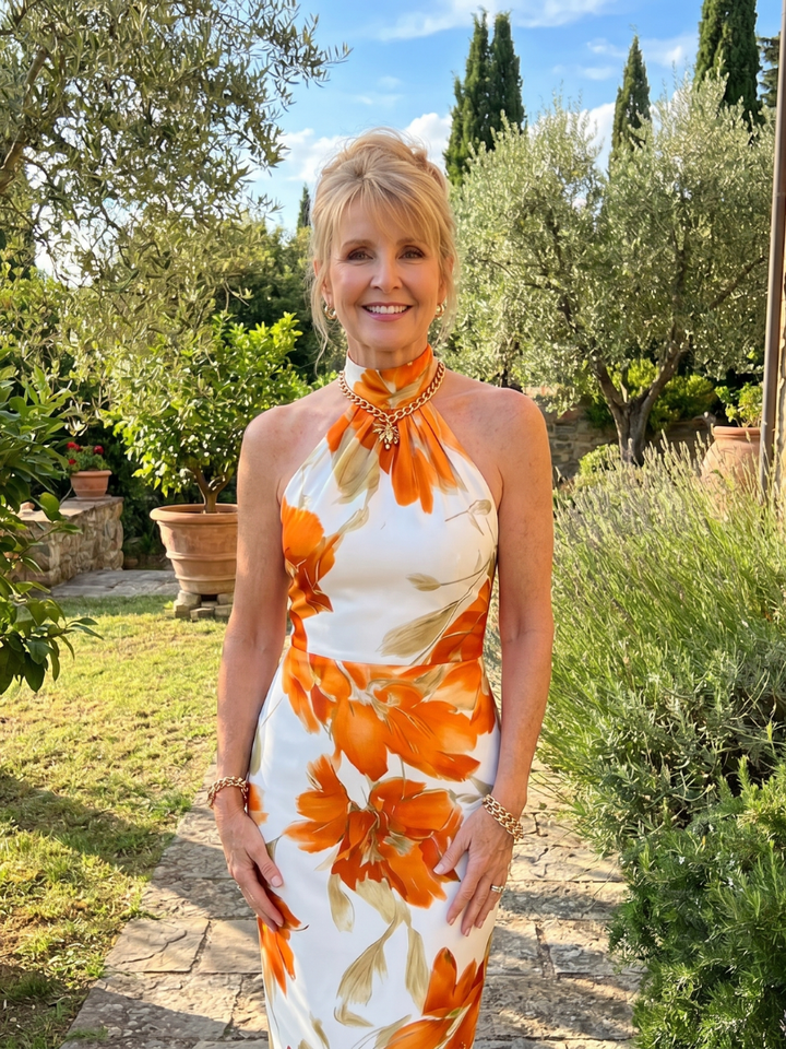 Veda Bremen Zinnara midikleid with neckholder and vibrant floral print, flowing fabric, and stylish silhouette.