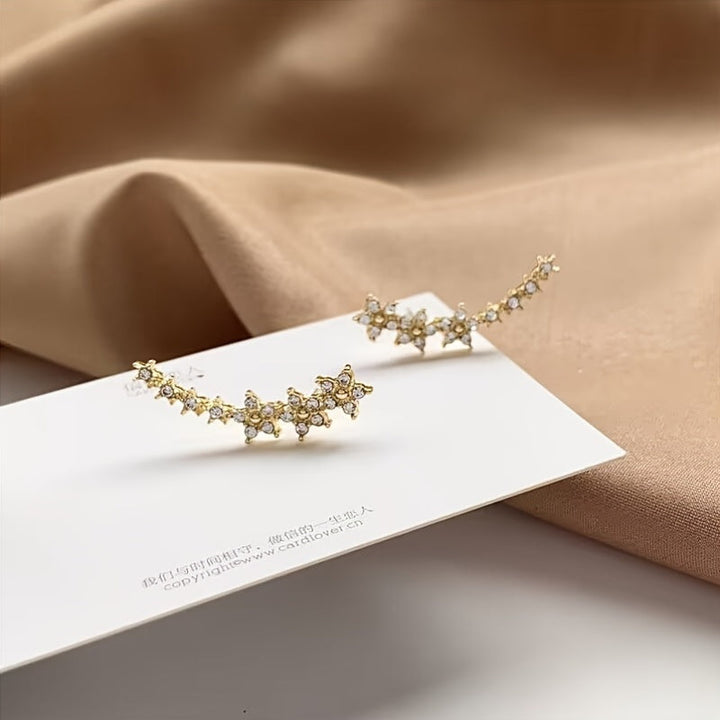 Veda Bremen timeless flower earrings featuring delicate floral design in silver with intricate petal details.