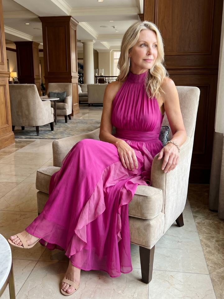 Veda Bremen Orea maxi dress with high neckline, ruching, and layered ruffle details, shown in a stylish fabric.