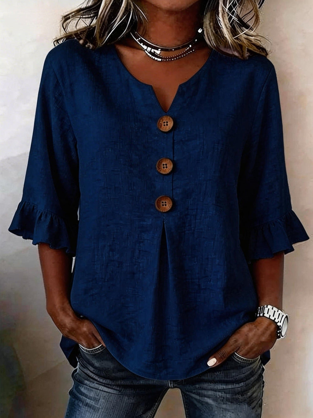 Veda Bremen Jessara linen blouse with ruffled sleeves, lightweight fabric, and a relaxed fit, shown in a natural, casual style.