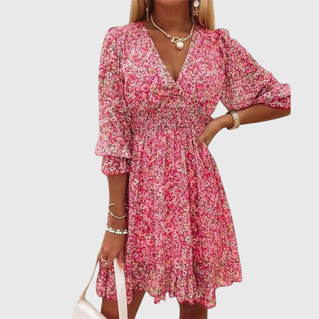 Veda Bremen Elisa floral puff-sleeve dress displayed on a mannequin, featuring a flowy design and vibrant floral pattern.