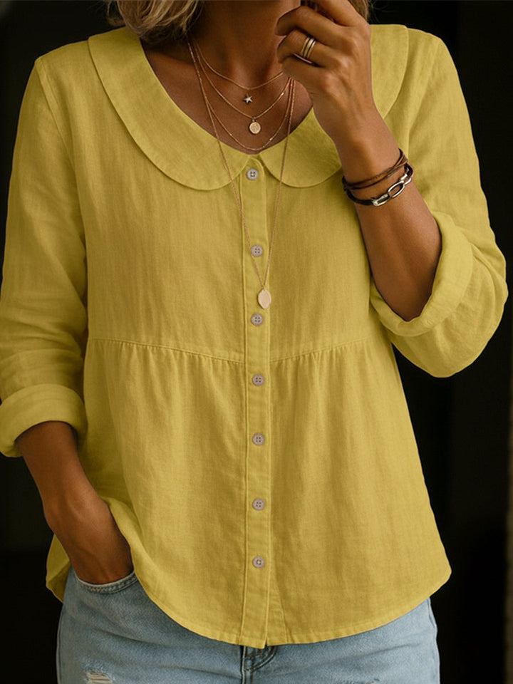 Veda Bremen Arlira linen blouse with Peter-Pan collar, soft textured fabric, shown on a hanger.