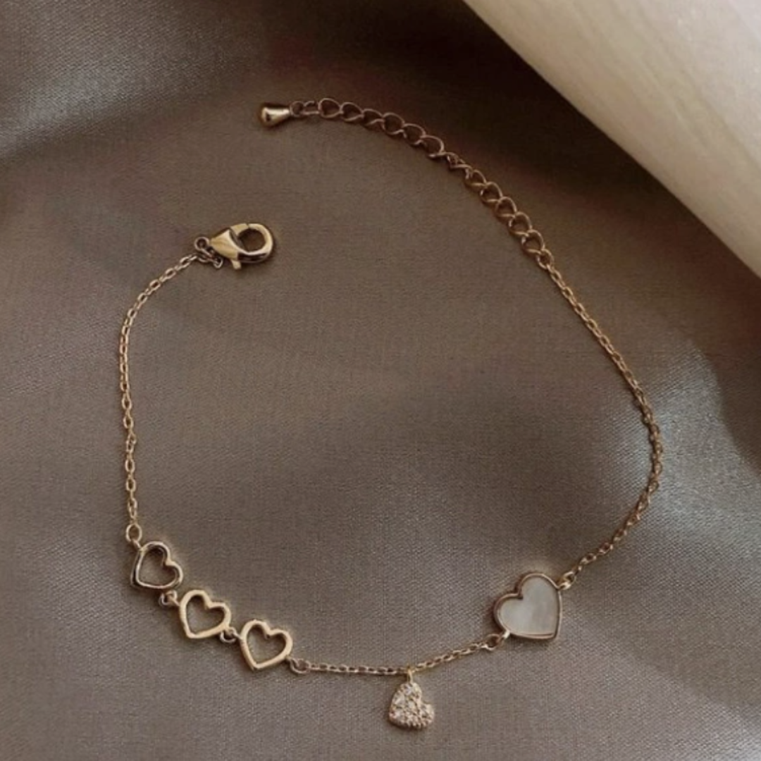 Veda Bremen Celeste charm bracelet with delicate charms on a sleek silver band, stylish accessory for everyday wear.