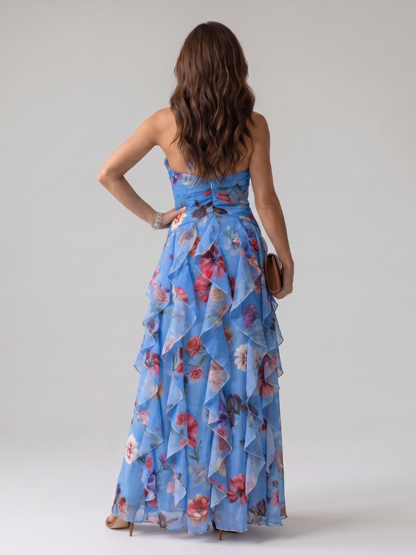 Veda Bremen Nori maxi dress with neckholder, gathered bodice, and floral print, displayed on a hanger against a neutral background.