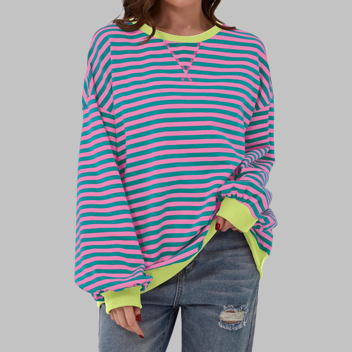 Veda Bremen LUKA striped long-sleeve top in soft fabric, ideal as a light spring layer, displayed on a hanger.