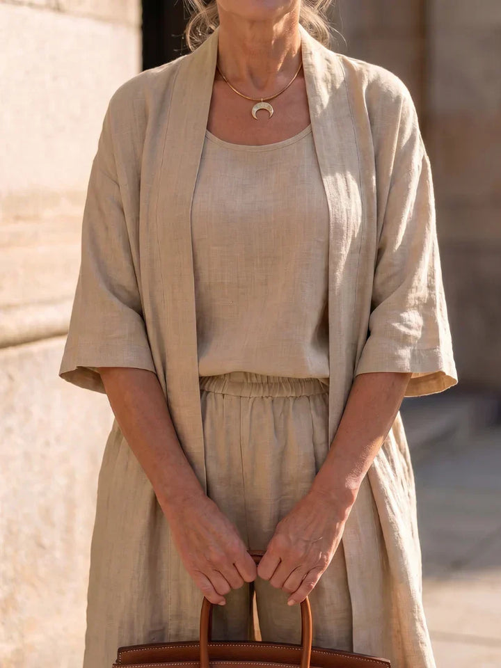 Veda Bremen Linnea lightweight linen set displayed on a hanger, featuring a relaxed-fit top and matching wide-leg pants in natural linen fabric.