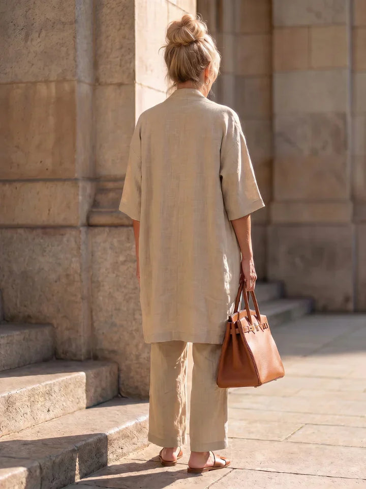 Veda Bremen Linnea lightweight linen set displayed on a hanger, featuring a relaxed fit and natural linen fabric in soft neutral tones.