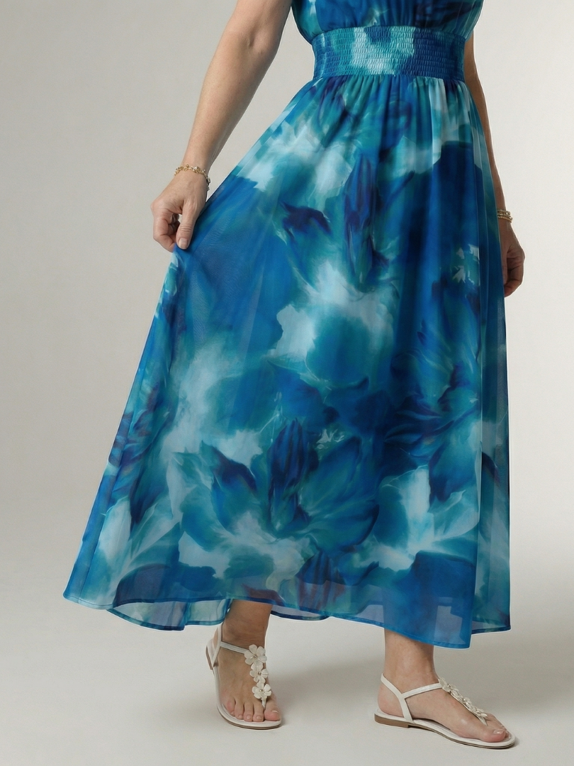 Veda Bremen Sylin mid-length dress with neckholder and ruffled details, displayed on a hanger against a neutral background.