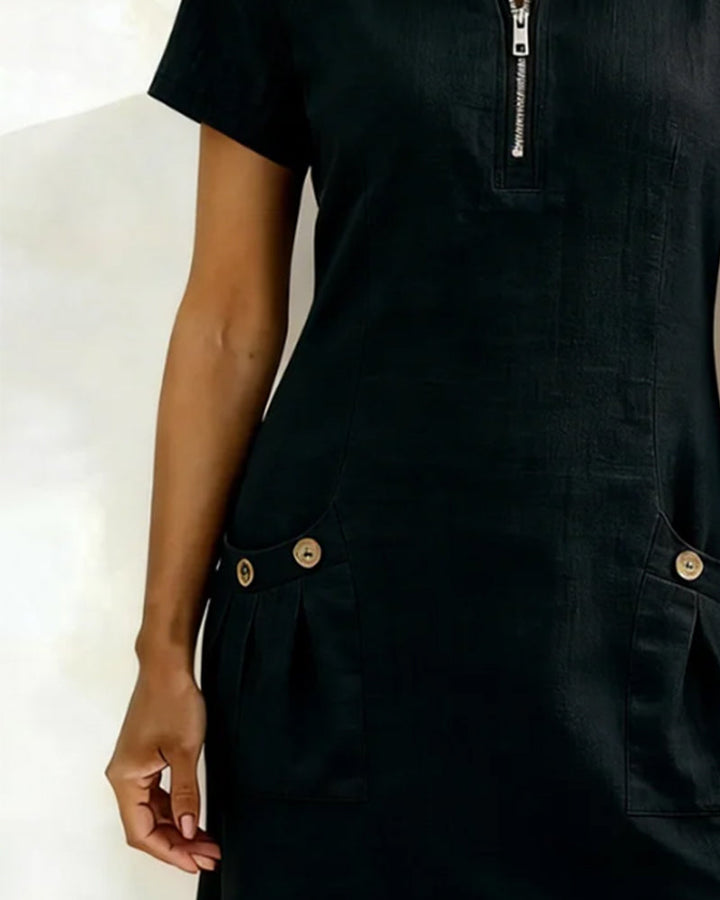 Veda Bremen Dariae linen blend A-line dress displayed on a hanger, featuring a flowing silhouette and natural fabric texture.