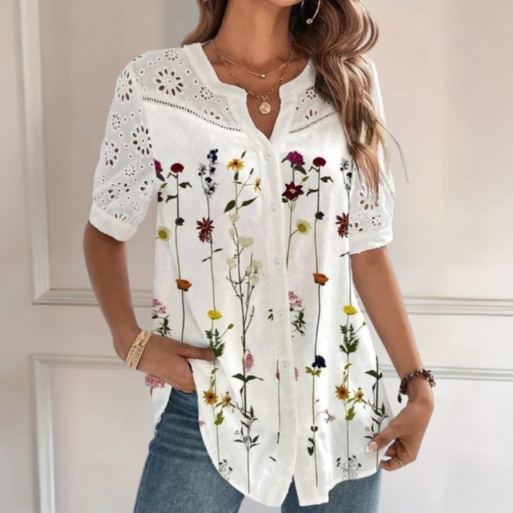 Veda Bremen Vivian casual blouse with lace and floral print, long sleeves, and a relaxed fit on a hanger.