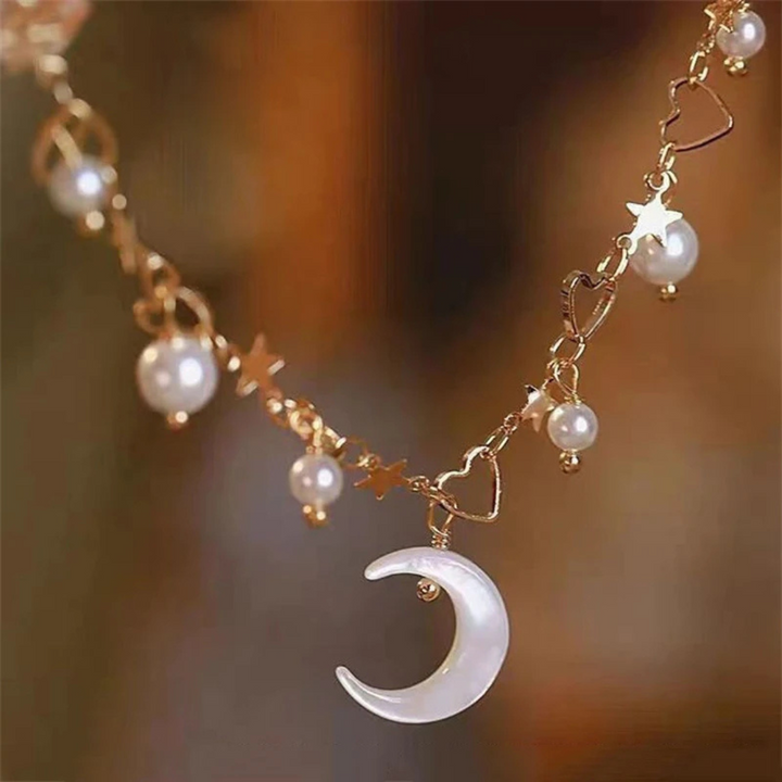 Veda Bremen Celeste charm bracelet featuring delicate silver charms on a sleek chain.