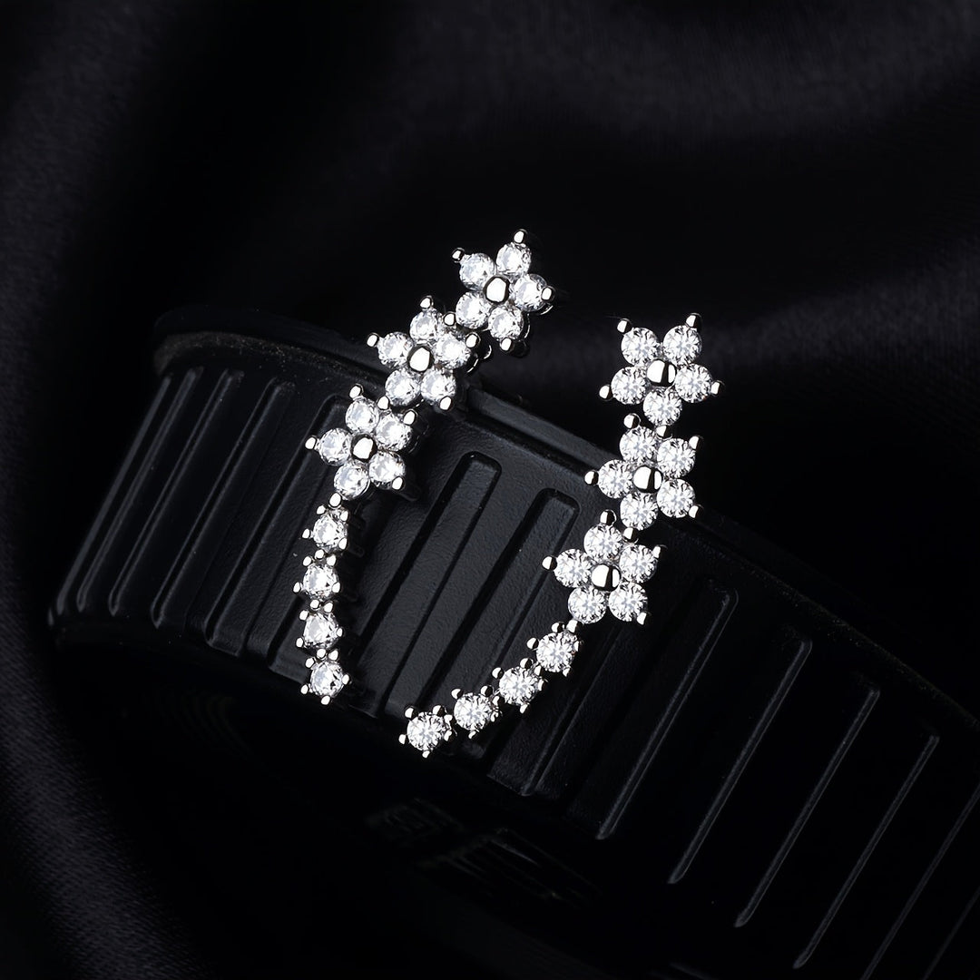 Veda Bremen timeless flower earrings featuring delicate floral design in silver with intricate detailing on a plain background