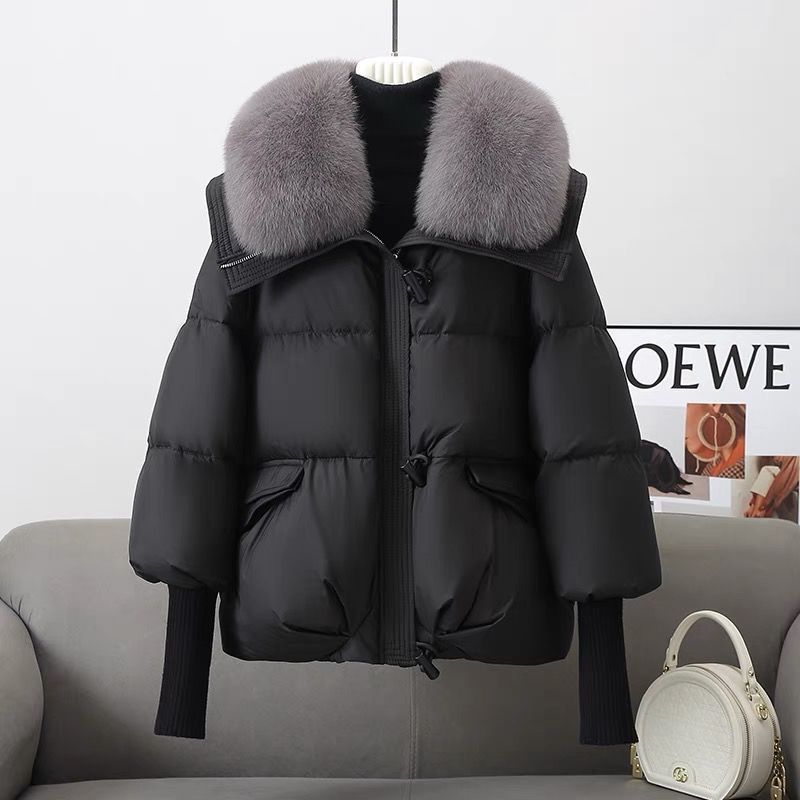 Black Vela Puffer Jacket by Lurolondon.co.uk, showcasing a stylish, insulated winter jacket with a quilted design and high collar.