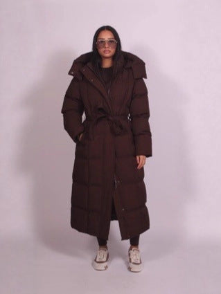 Brown long puffer coat by Lurolondon, featuring a quilted design and hooded style for warmth and style.