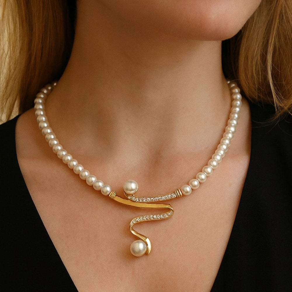 Elegant wave-shaped pearl jewelry set by Veda Bremen featuring matching earrings and necklace on a white background.