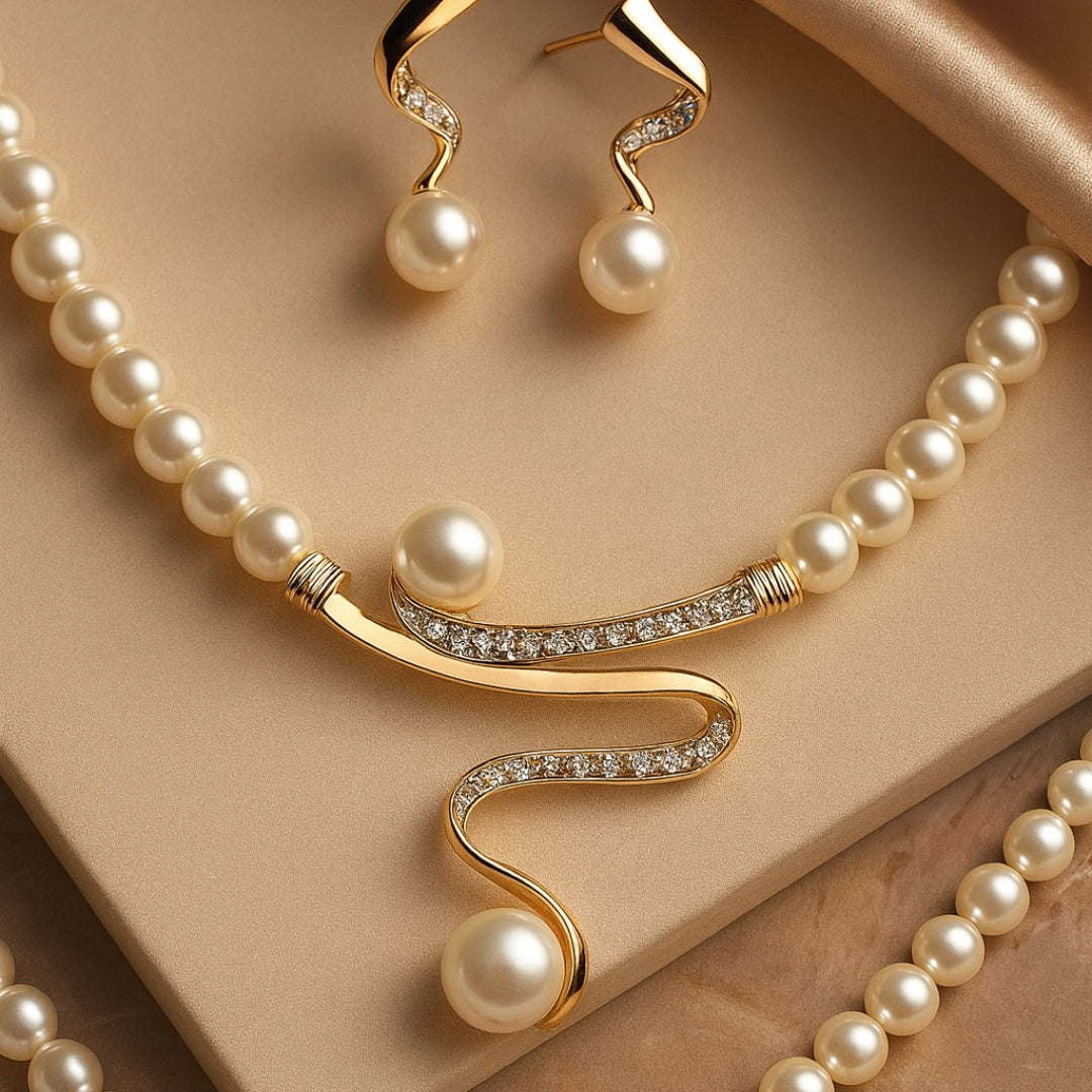 Elegant wave-shaped pearl jewelry set by Veda Bremen, featuring matching necklace and earrings with lustrous white pearls.
