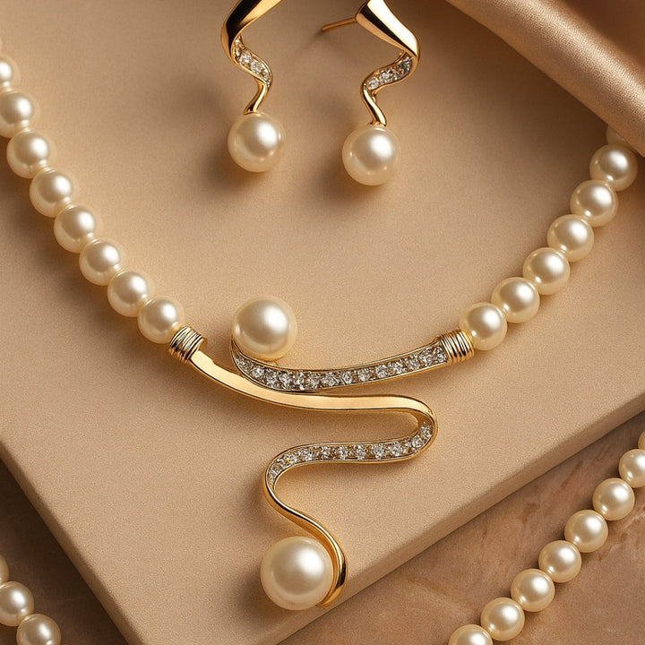 Elegant wave-shaped pearl jewelry set by Veda Bremen, featuring matching necklace and earrings with lustrous white pearls.