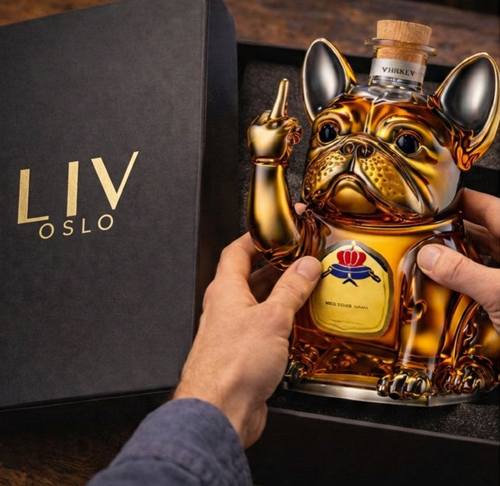 Veda Bremen Hunde Edition whisky bottle with dog-themed label, clear glass bottle with cork stopper, front view.
