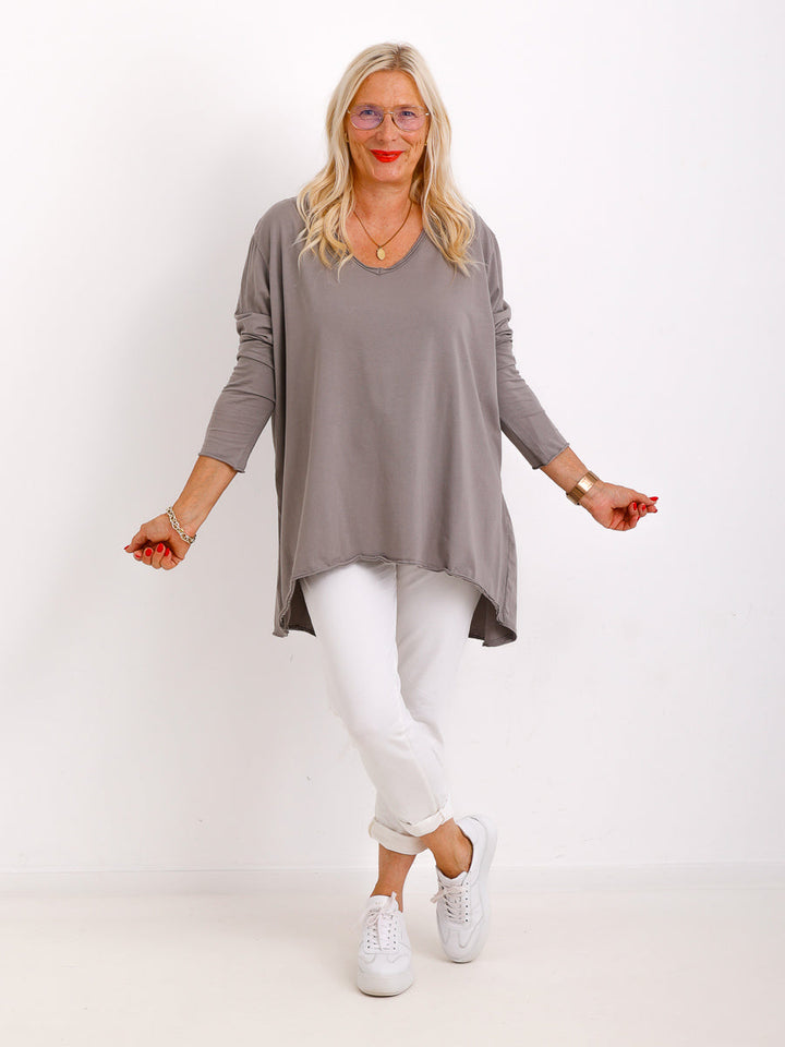Veda Bremen Brenda Langarmshirt, stylish long-sleeve top in neutral fabric, displayed on a hanger.