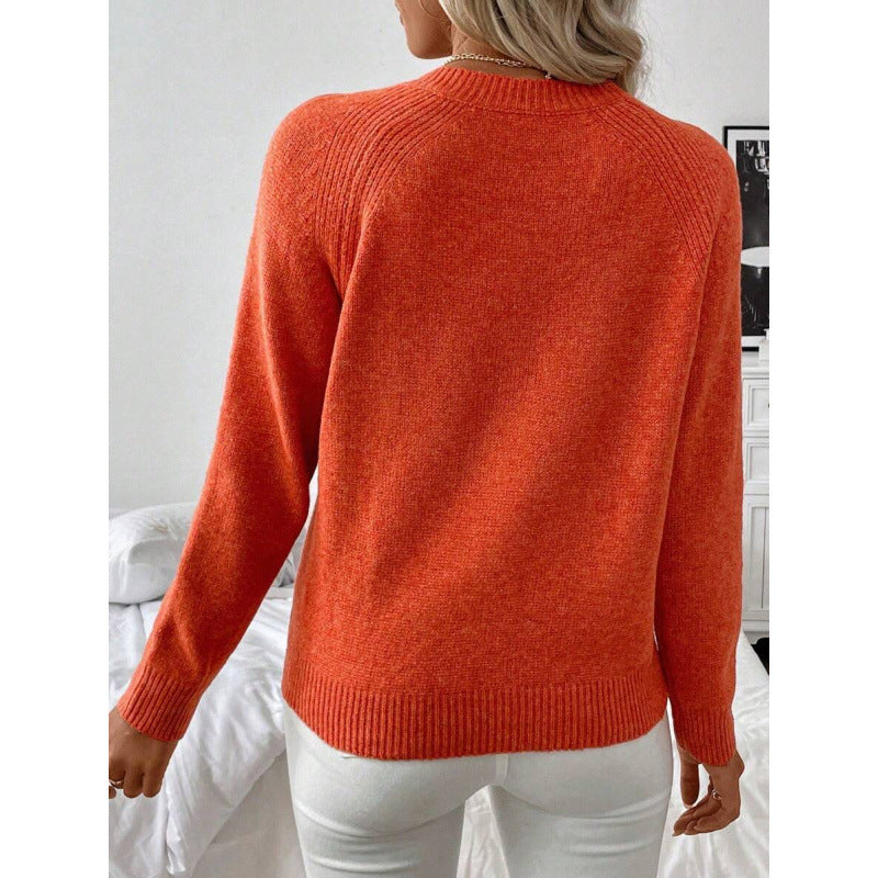 LuroLondon button-decorated sweater in soft knit with large buttons, displayed on a neutral background.