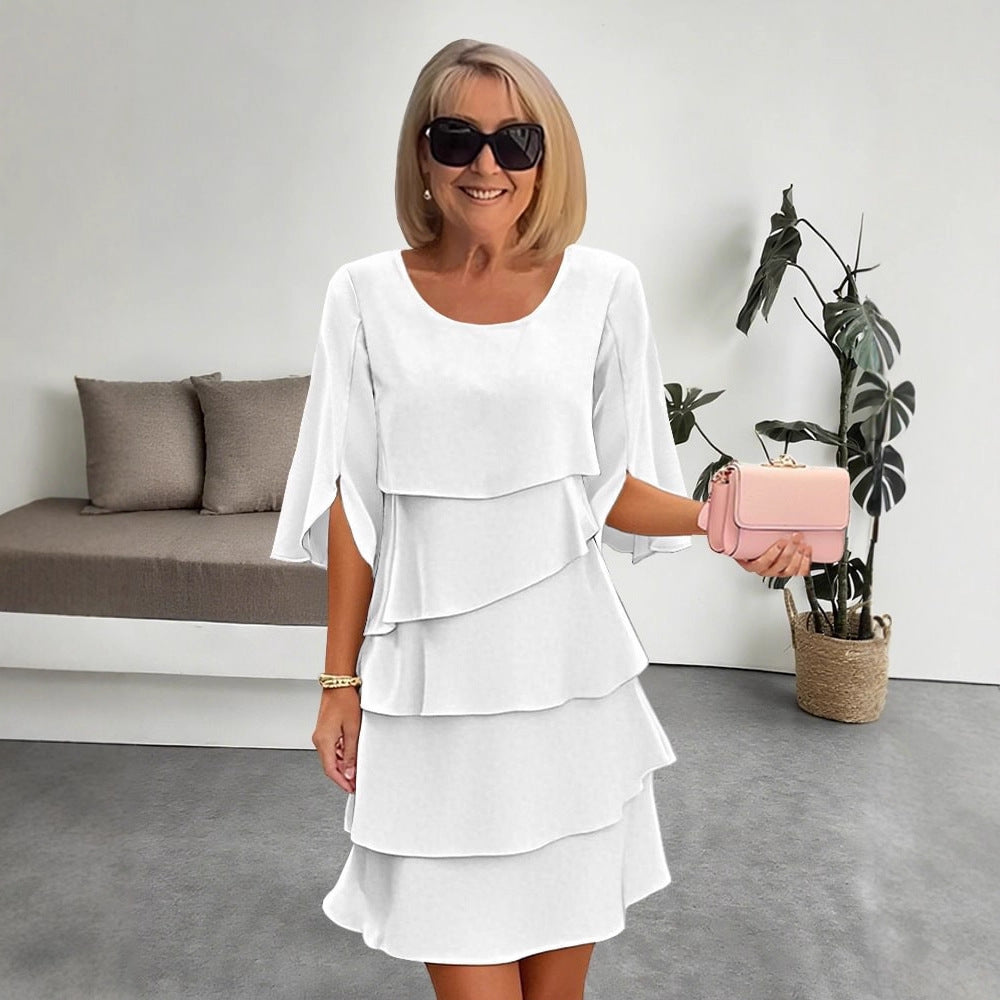Veda Bremen layered dress with ruffles, featuring a feminine design and flowing fabric, perfect for elegant occasions.