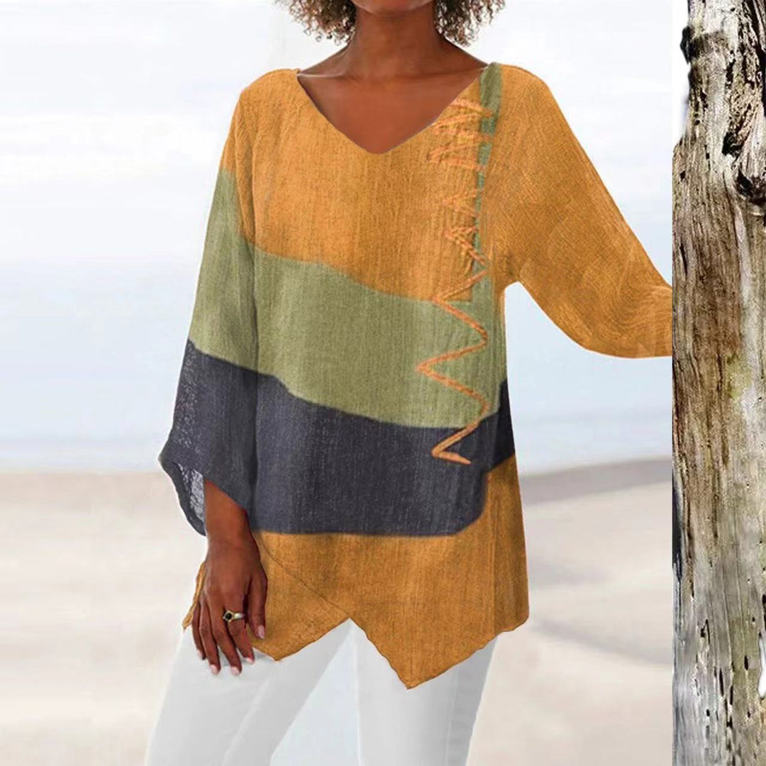 Light beige Veda Bremen summer blouse with flowing fabric and elegant design, displayed on a hanger.