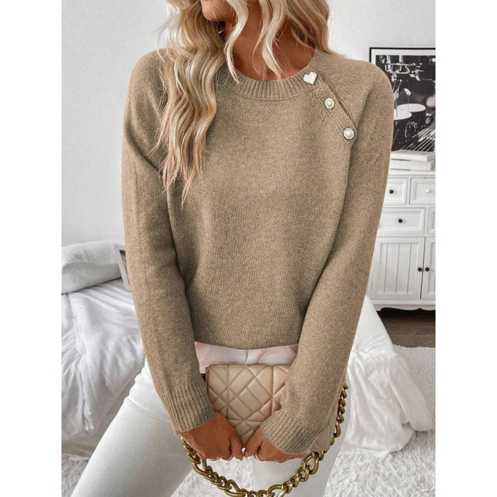 LuroLondon Button-Decorated sweater featuring a cozy knit design with decorative buttons on the front.