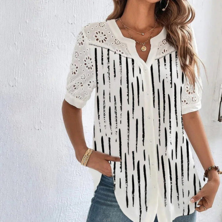 Veda Bremen Vivian casual blouse with lace and floral print, lightweight fabric, and relaxed fit, displayed on a hanger.