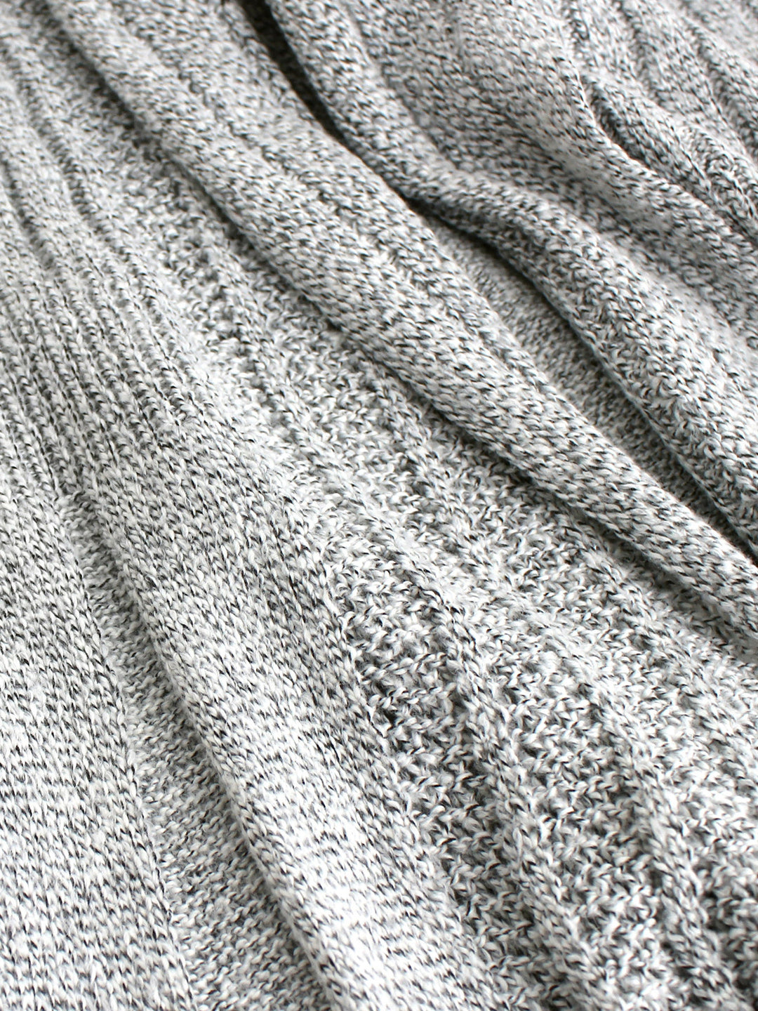 Veda Bremen knitted cardigan with textured structure, featuring a cozy, stylish design and ribbed cuffs on a neutral background.
