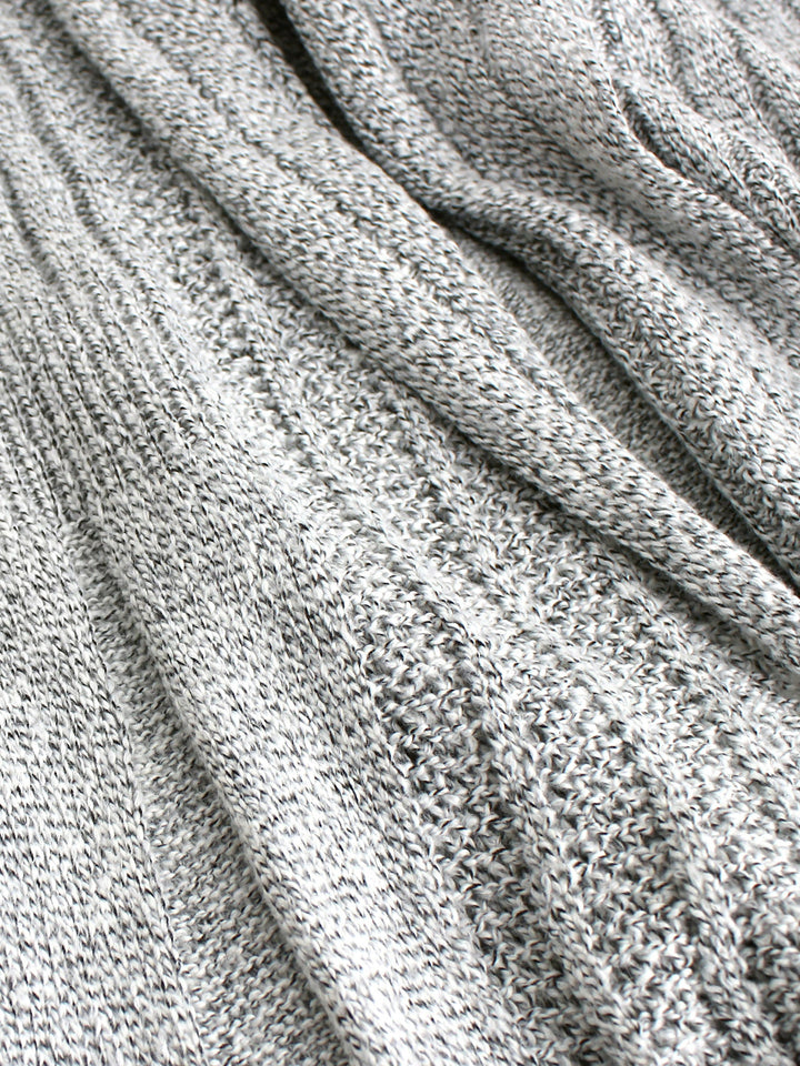Veda Bremen knitted cardigan with textured structure, featuring a cozy, stylish design and ribbed cuffs on a neutral background.