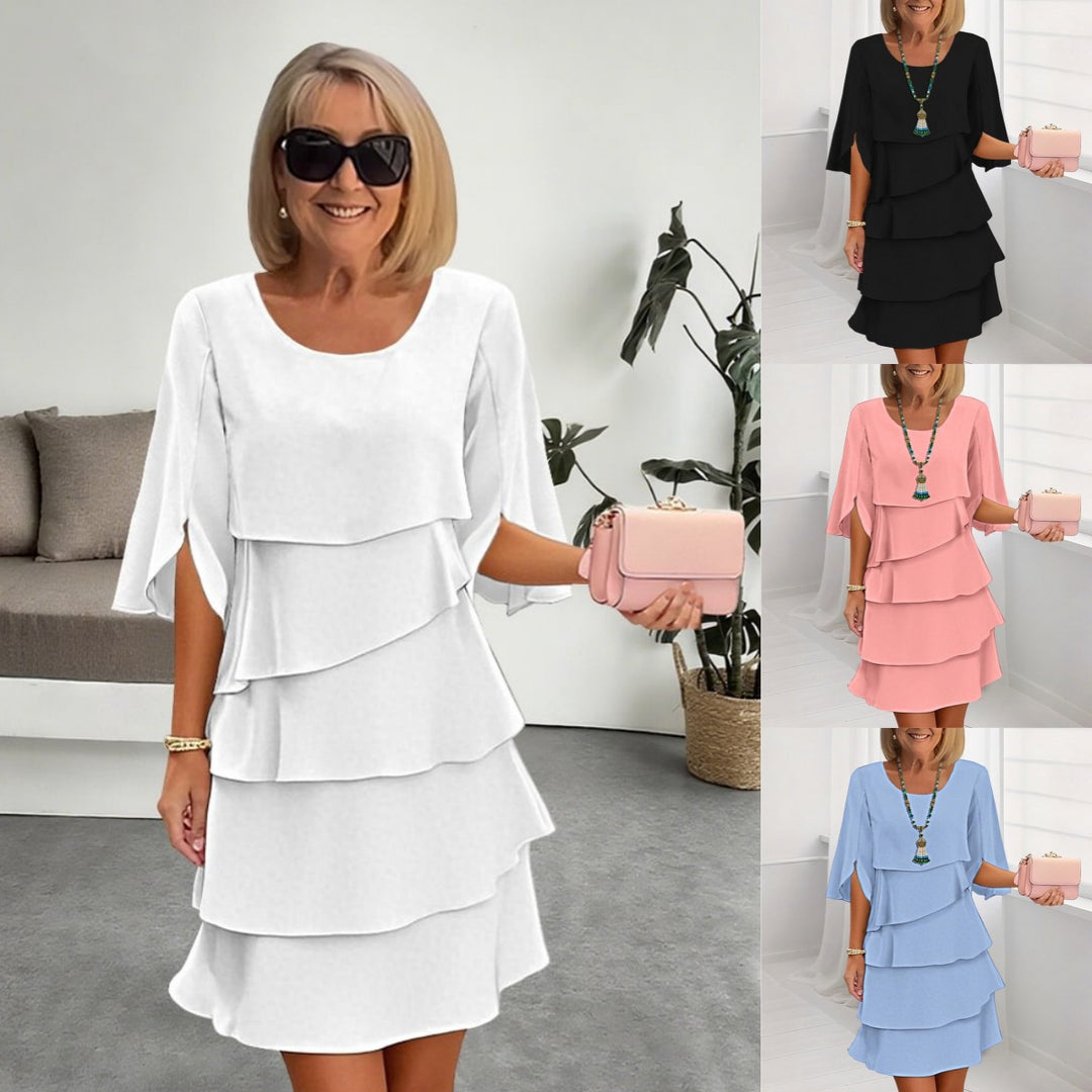 Veda Bremen layered dress with ruffles, featuring a stylish and feminine design, displayed on a hanger.