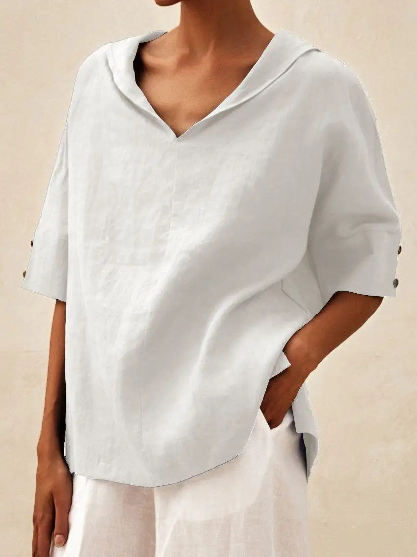 Classic Veda Bremen linen blouse with V-neck, shown in natural fabric with relaxed fit and elegant design.