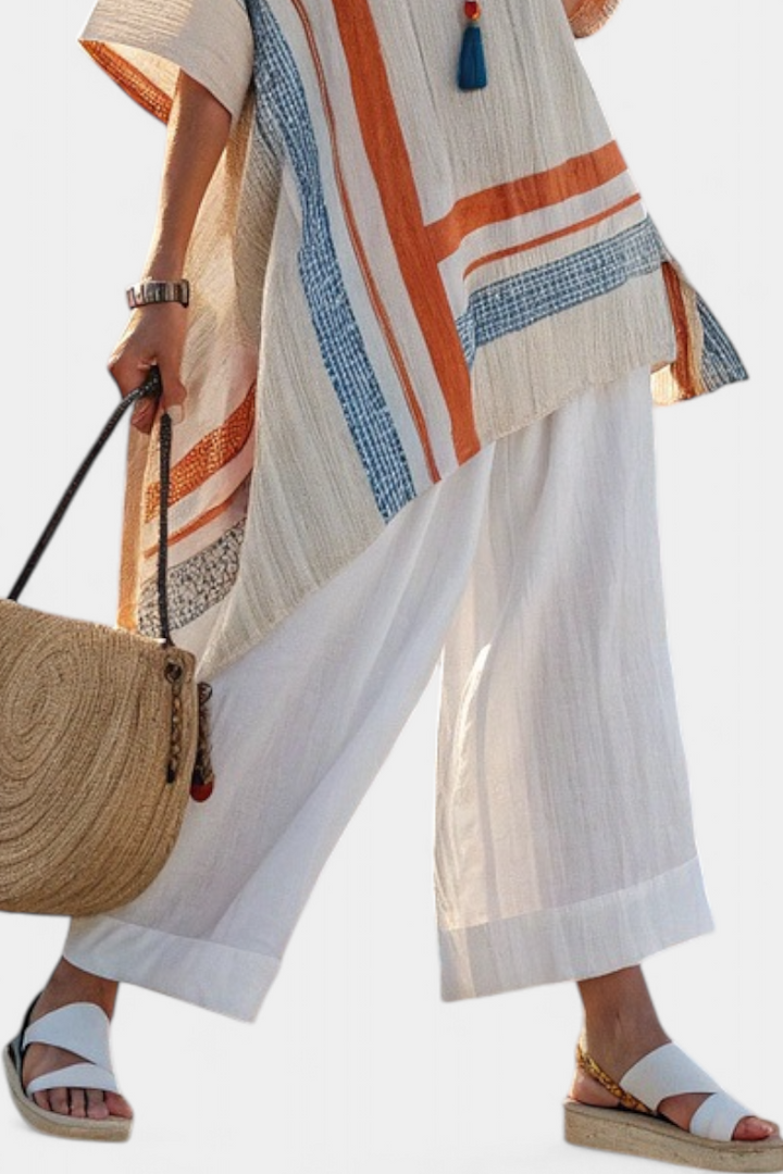 Veda Bremen Caevan set with a refined asymmetrical blouse and wide linen pants, stylish and comfortable for casual wear.