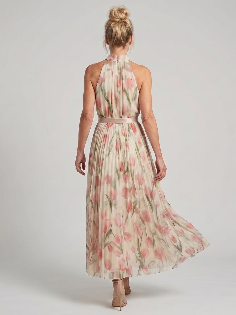 Veda Bremen Aurelle floral midi dress with halter neck and blooming pattern, shown hanging on a white background.
